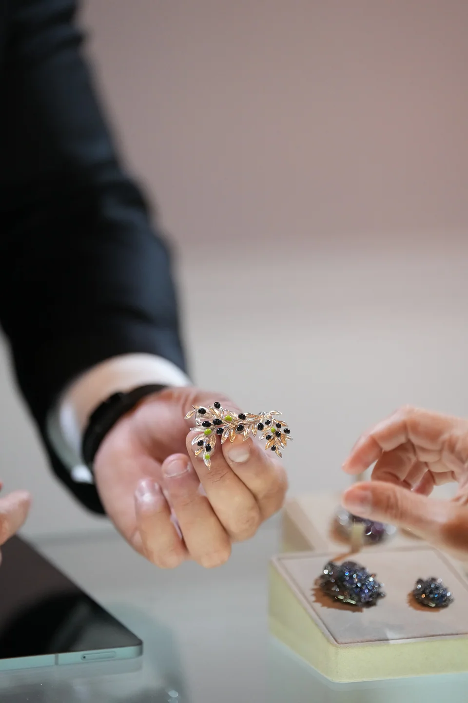 A piece of D’Evin jewellery being examined up close.